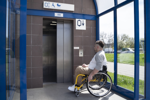 full-shot-disabled-man-taking-elevator